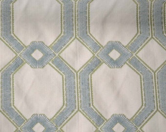 May include: White fabric with a geometric pattern of blue and green octagons and diamonds.