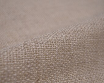 May include: Close-up of a natural beige burlap fabric with a woven texture.