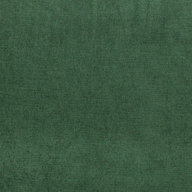 May include: A close-up of a dark green fabric with a textured surface.