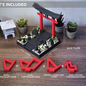 May include: A gaming accessory set featuring a black base plate (6.5in x 7.3in), a red Torii gate, and miniature plants. Includes red controller stands for single, dual, and Joycon controllers, and a Switch game case stand. The text "WHAT'S INCLUDED" is at the top.