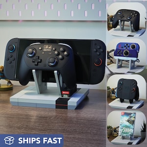 May include: A black Nintendo Switch controller and console stand with a retro design. The stand holds the Switch console and a controller, with a Zelda game cartridge visible. The image also shows other controller designs.