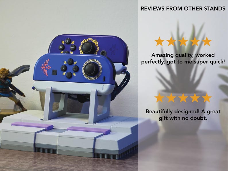 May include: A blue and white video game controller stand with a retro design. The stand holds two controllers and features a gray base with purple accents. The controllers are blue with black buttons and gold accents. The text "REVIEWS FROM OTHER STANDS" is visible.