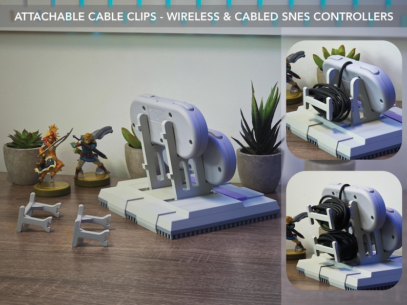 May include: A gray and purple SNES controller stand with attachable cable clips. The stand holds a wireless controller and has a base with a purple accent. The image also shows small figurines and potted plants.