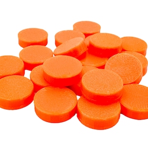 May include: A pile of orange, circular game pieces. Each piece is a solid, flat disc with a slightly textured surface. The pieces are stacked and scattered, creating a visually appealing arrangement against a white background.