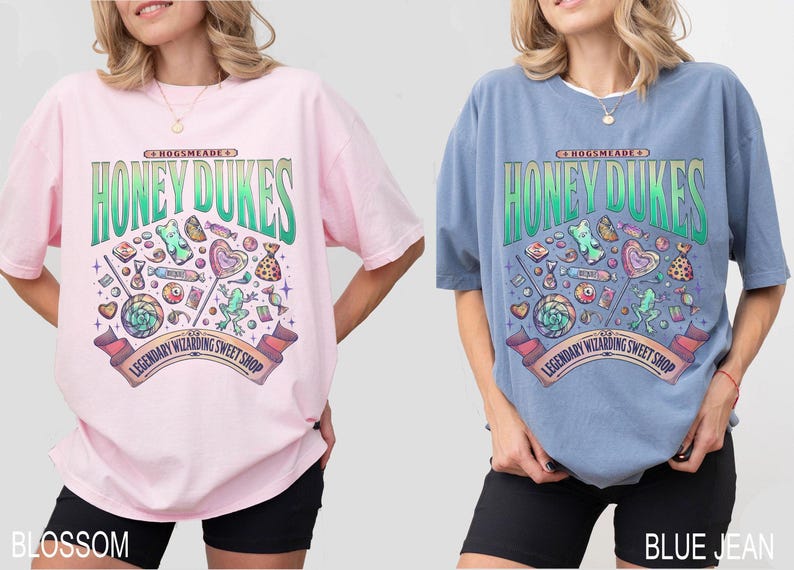May include: Two oversized t-shirts, one pink and one blue, each featuring a graphic for Honeydukes, a legendary wizarding sweet shop. The design includes candies, lollipops, and the shop's name in a green and white font.
