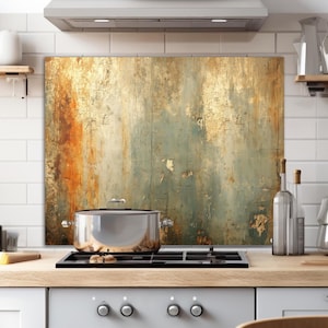 May include: A stainless steel pot sits on a black stovetop in a kitchen. A decorative backsplash with a distressed, textured design in shades of gold, orange, and teal is behind the stove. Kitchen decor includes shelves, bottles, and a cutting board.