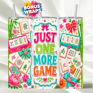 May include: Three cylindrical tumblers with metal straws featuring a colourful Mahjong theme. The design includes Mahjong tiles with Chinese characters, pink bows, green bamboo stalks, dice, and flowers. The centre tumbler displays the text JUST ONE MORE GAME.