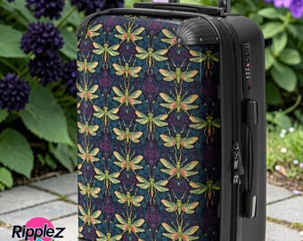 May include: A black rolling suitcase with a patterned design of green and yellow insects on a dark blue background. The suitcase has a retractable handle and four wheels. The brand name "Ripplez" is visible on the side.