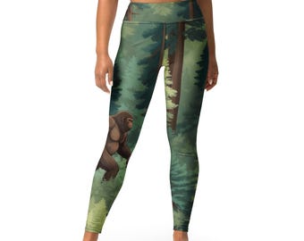 May include: Green, black, and brown leggings with a forest scene and a large, brown Bigfoot walking through the trees.