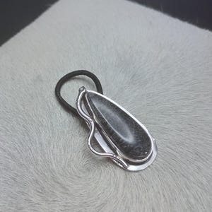 May include: A set of three ceramic mugs with a speckled, matte finish in cream, light grey, and dark grey. Each mug has a simple, minimalist design and a rounded handle.