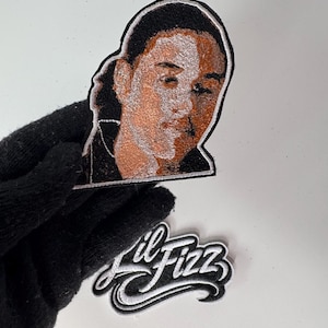 May include: A white ceramic mug with a black handle and the text "But First, Coffee" in a bold, black font. The mug is set against a neutral background, highlighting its simple design.