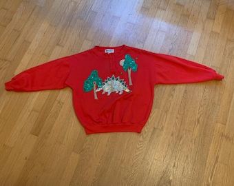 Vintage rode sweater uit de jaren 80 met pailletten en dinosaurusprint (Stegosaurus), maat S.