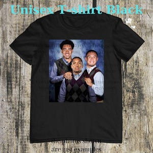 May include: Black unisex t-shirt featuring a group photo of three people wearing argyle vests over collared shirts. The text "Unisex T-shirt Black" is at the top, and "the photos shown are just examples" is at the bottom.