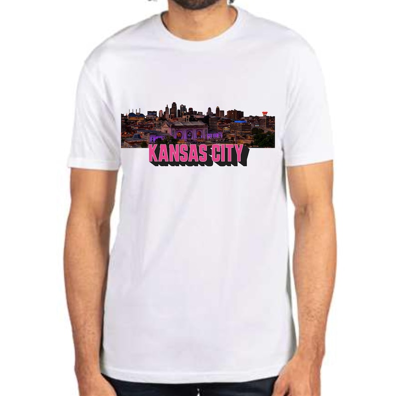 May include: White t-shirt with a skyline image of Kansas City and the text "KANSAS CITY" in pink.