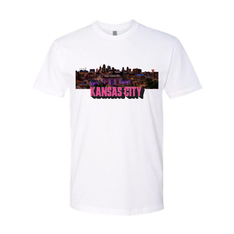 May include: White t-shirt with a skyline image of Kansas City and the text "KANSAS CITY" in pink.