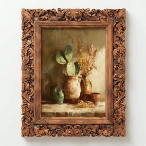 May include: An oil painting of a still life with a decorative, ornate, brown wooden frame. The painting depicts a cactus, dried flowers, and pottery. The frame has detailed carvings. The color palette includes shades of brown, green, and beige.