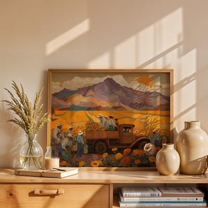 May include: A framed painting depicts a harvest scene with a truck loaded with sunflowers, figures in hats, and a mountain backdrop. The artwork is displayed on a wooden dresser with vases, books, and a glass vase with wheat.