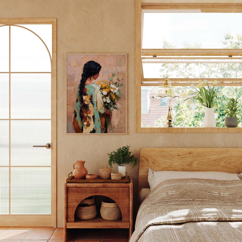 May include: An oil painting of a person holding a bouquet of flowers, framed and hanging on a wall. The person is wearing a teal and cream-colored garment. The room features a wooden nightstand, a bed, and a window with plants.