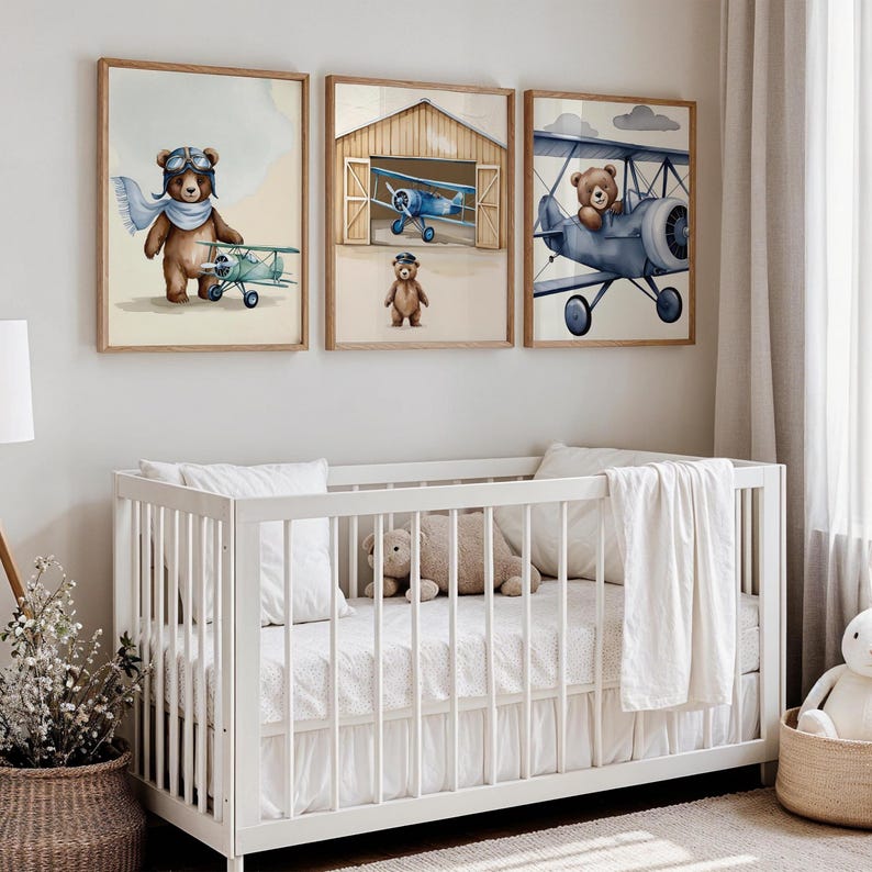 Set of 3 digital nursery prints featuring an aviator bear, vintage biplanes, and cozy airplane hangar scenes. Perfect for an aviator nursery, airplane nursery, baby boy travel room, pilot baby room, vintage nursery decor, and adventure-themed baby rooms. Ideal wall art for baby showers, nursery wall displays, and cozy baby room corners. Soft neutral colors with a classic vintage aviation theme.