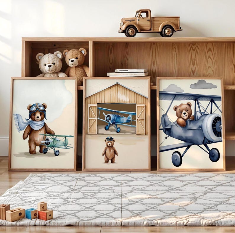 Set of 3 digital nursery prints featuring an aviator bear, vintage biplanes, and cozy airplane hangar scenes. Perfect for an aviator nursery, airplane nursery, baby boy travel room, pilot baby room, vintage nursery decor, and adventure-themed baby rooms. Ideal wall art for baby showers, nursery wall displays, and cozy baby room corners. Soft neutral colors with a classic vintage aviation theme.