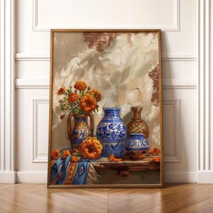 May include: A framed still life painting featuring a collection of vases and orange flowers. The vases are in various shapes and sizes, with blue and white patterns. A blue and orange patterned cloth is draped over a wooden surface.