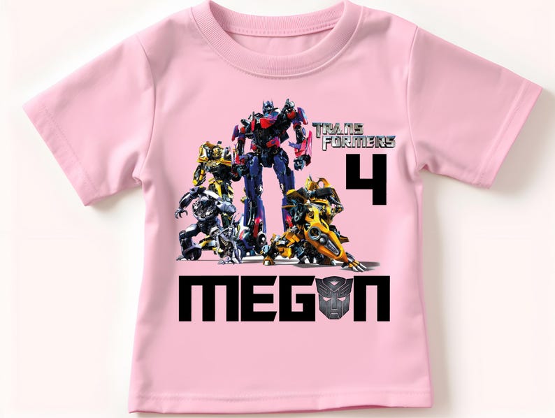 May include: Pink t-shirt with a Transformers graphic, the number 4, and the name Megan.