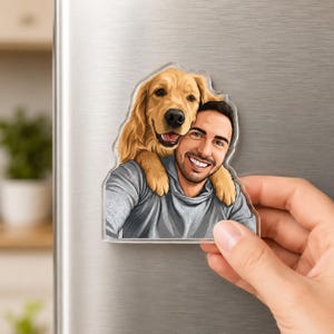 May include: A clear acrylic magnet featuring a smiling man and a golden retriever dog. The dog is positioned behind the man, with its head resting on his shoulder. The man is wearing a gray hoodie.