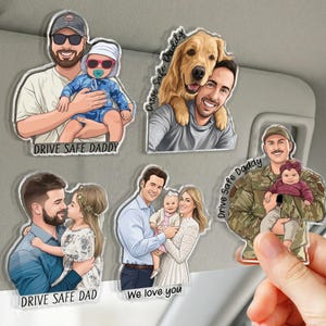 May include: A collection of clear acrylic car charms featuring cartoon illustrations of families and individuals. Each charm has a unique design, including a father holding a baby, a man with a dog, and a family with a baby. Text includes "DRIVE SAFE DADDY" and "We love you."