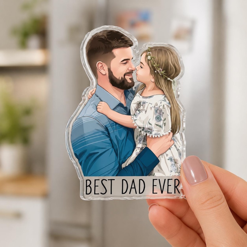 May include: A clear acrylic magnet featuring an illustration of a father and daughter embracing. The father wears a blue shirt, and the daughter wears a floral dress. The text "BEST DAD EVER" is at the bottom. The magnet is held by a hand.