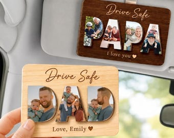May include: Two wooden car visor ornaments. One is dark brown with "Drive Safe PAPA I love you" and photos. The other is light wood with "Drive Safe DAD Love, Emily" and photos. Both have a metal clip.