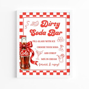 May include: A rectangular sign with a red and white checkered border featuring a glass cola bottle with a red bow. The text reads Dirty Soda Bar, Fill glass with ice, Choose your soda, Add syrup, Mix in cream, and Garnish & enjoy, with illustrations.