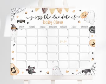 May include: A white easel displaying a calendar for a baby shower game. The calendar features Halloween decorations like ghosts, pumpkins, spiders, and bats. The text reads "guess the due date of baby Olivia."