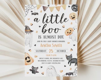 May include: A Halloween-themed baby shower invitation with the text "a little boo is almost due." The design includes ghosts, pumpkins, bats, spiders, and a black cat. The invitation is for Amelia Smith's baby shower, scheduled for October 25th.
