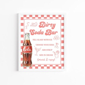 May include: A rectangular sign with a pink and white checkered border featuring the text Dirty Soda Bar. It includes a brown glass cola bottle and illustrations of ice cubes, a cocktail glass, and a drink with a slice of citrus fruit.