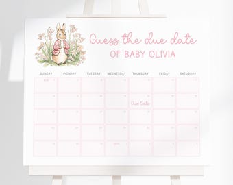 May include: A white calendar on an easel with pink text that reads "Guess the due date of Baby Olivia." A watercolor illustration of a bunny is in the upper left corner. The calendar grid is pink with dates.