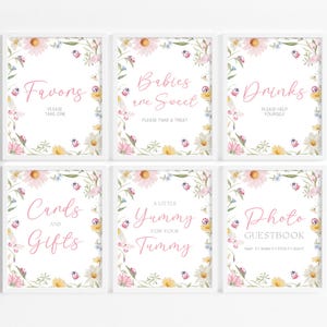 May include: Six white-framed signs featuring floral borders with daisies, wildflowers, and ladybugs. The signs display text: Favors, Babies are Sweet, Drinks, Cards and Gifts, A Little Yummy for Your Tummy, and Photo Guestbook with instructions.