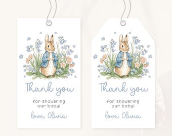 May include: Two white gift tags with a watercolor illustration of a rabbit in a blue jacket surrounded by flowers. The tags read "Thank you for showering our baby! love, Olivia."