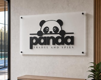 Puede incluir: Un letrero rectangular de acrílico esmerilado montado con herrajes negros, con un gráfico negro de un panda asomándose sobre una línea horizontal. Debajo, el texto dice "panda" en letras negritas y "FRADEL AND SPIES" debajo.