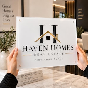 May include: A rectangular white acrylic sign featuring the black text HAVEN HOMES REAL ESTATE and the slogan FIND YOUR PLACE. The logo includes a large black letter H with a gold roof graphic and a small window icon. Four corner holes are visible.