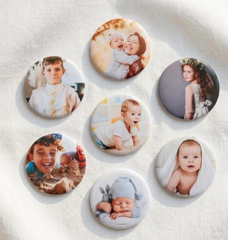 May include: Seven circular photo badges featuring various portraits of children and infants. The images include a child in a white shirt, a person holding a baby, a child in a floral crown, a crawling baby, a laughing child, and a sleeping baby.