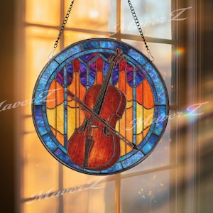 May include: A round stained glass window featuring a cello and bow. The window has a blue border and a colorful design with orange, yellow, and red hues. The cello is brown with black details, and the bow is positioned across it.