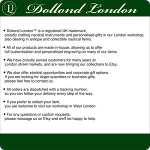 May include: A white informational sign with a dark green header featuring the text Dollond London. The text details the company's history as a UK trademark, their focus on nautical instruments, custom engraving services, and contact information.
