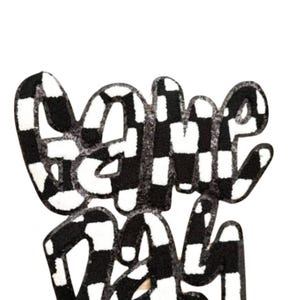 May include: A black and white checkered design with the words "Game Day" in a playful, stylized font. The letters are thick and rounded, with a textured appearance. The background is plain white.