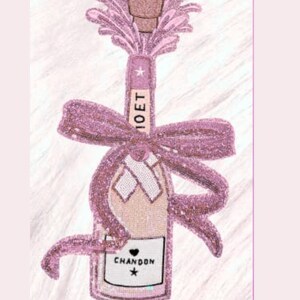 May include: A decorative champagne bottle design with pink sequins and a bow. The bottle features the text "MOET" and "CHANDON" with a star. The design is set against a white, textured background.