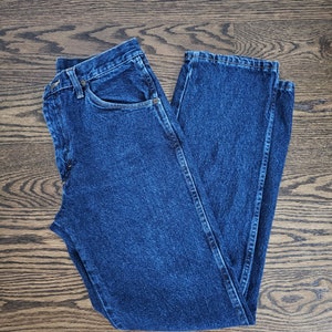 May include: A pair of blue denim jeans with a classic straight leg fit.