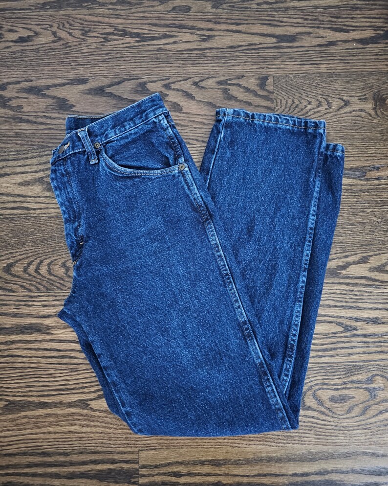May include: A pair of blue denim jeans with a classic straight leg fit.