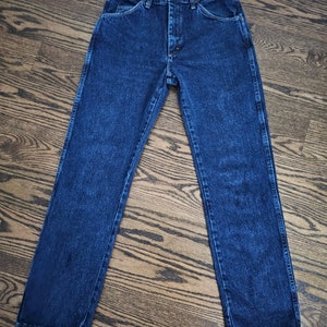 May include: A pair of dark blue denim jeans with a classic straight leg fit.