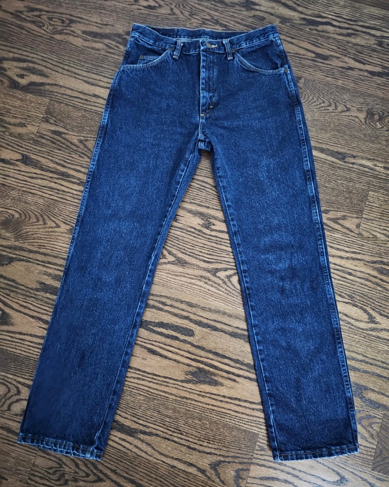 May include: A pair of dark blue denim jeans with a classic straight leg fit.