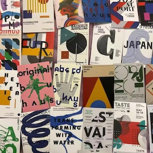 May include: A selection of vintage art posters with striking typography and geometric patterns. The posters display a range of colours, including red, blue, yellow, and black. Some posters feature text such as "Bauhaus" and "Jazz Port".