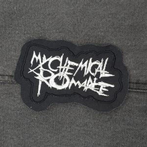 Könnte beinhalten: Schwarz-weiß gestickter Patch mit den Worten "My Chemical Romance" in einer stilisierten Schrift.